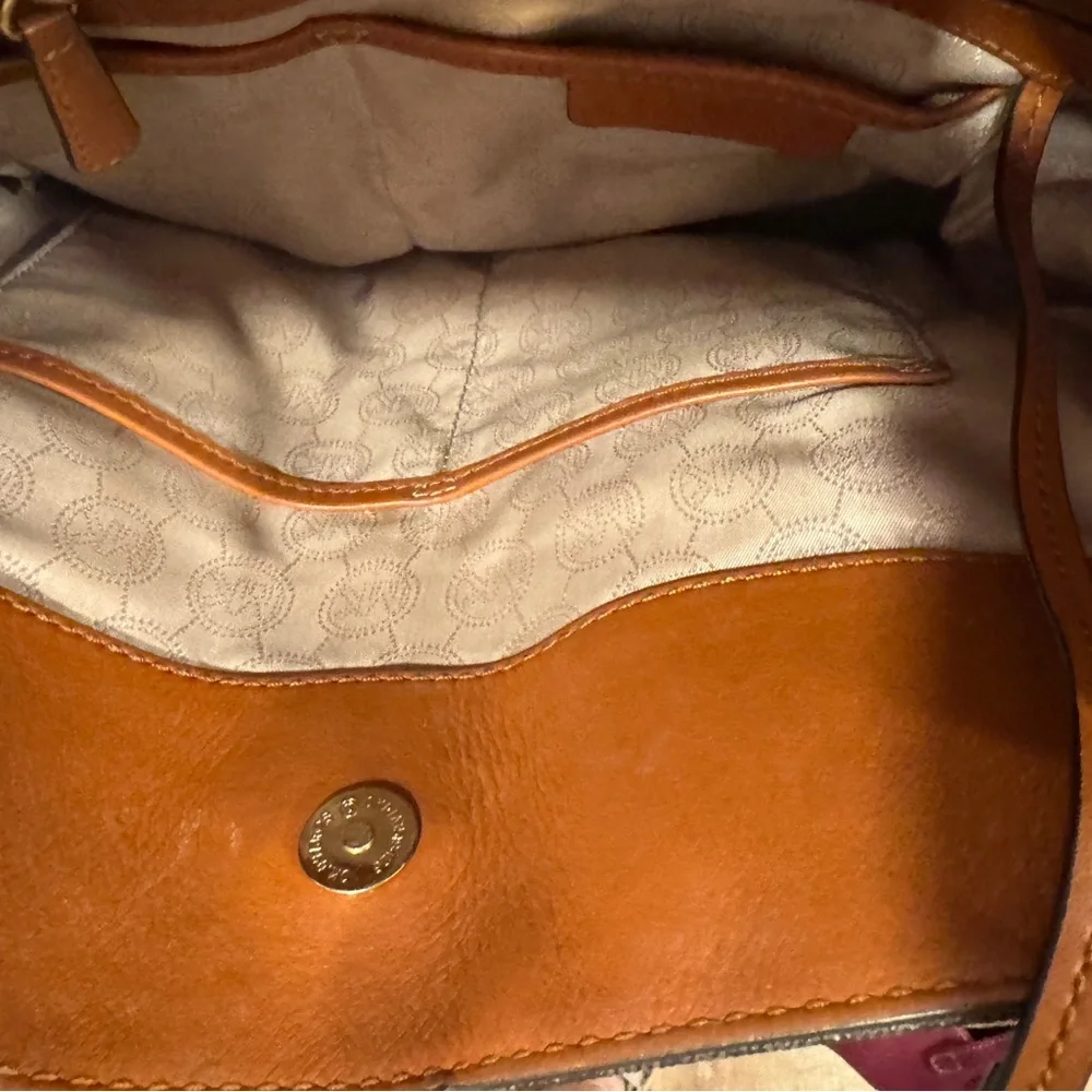 Michael Kors Emblemed satchel style purse. Strap has some gold chain and leather